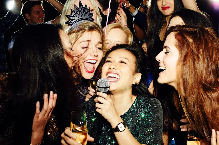 group of women singing karaoke