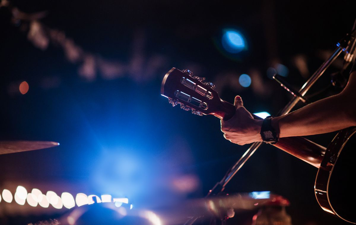 man on stage playing guitar ashland ohio live music events join a music group