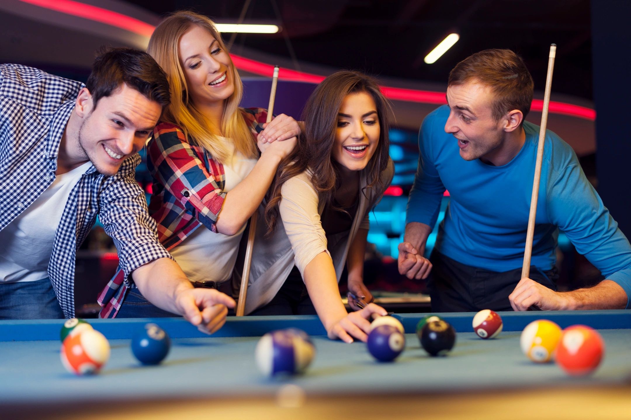 people playing pool in a bar
