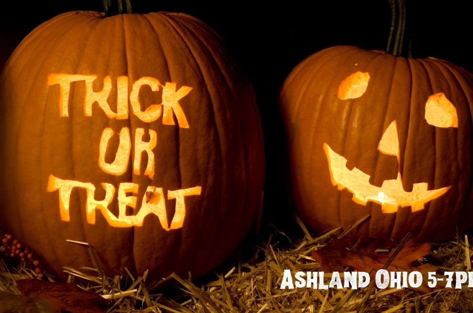 two jack o lanterns, one carved with trick or treat, the other a traditional jack o lantern face