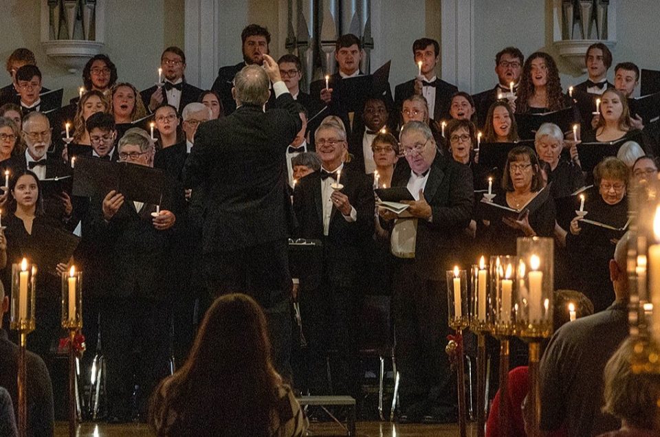 Ashland University Choirs performing during a previous Festival of lights concert. Holding lit candles, candelabras decorating the space