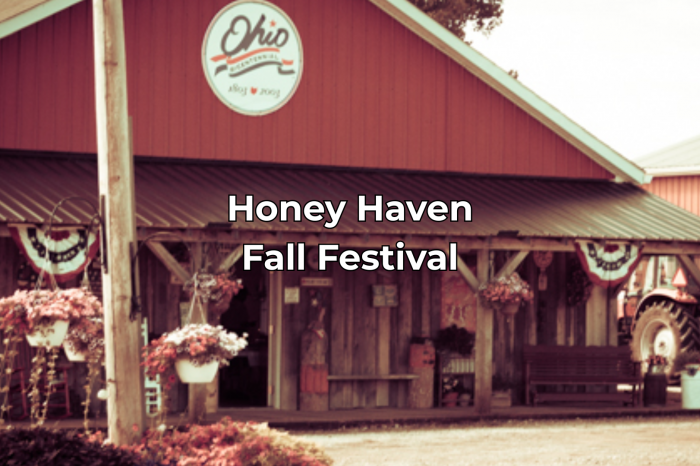 The front of the Honey Haven Country store in the fall with a big front porch and flowers