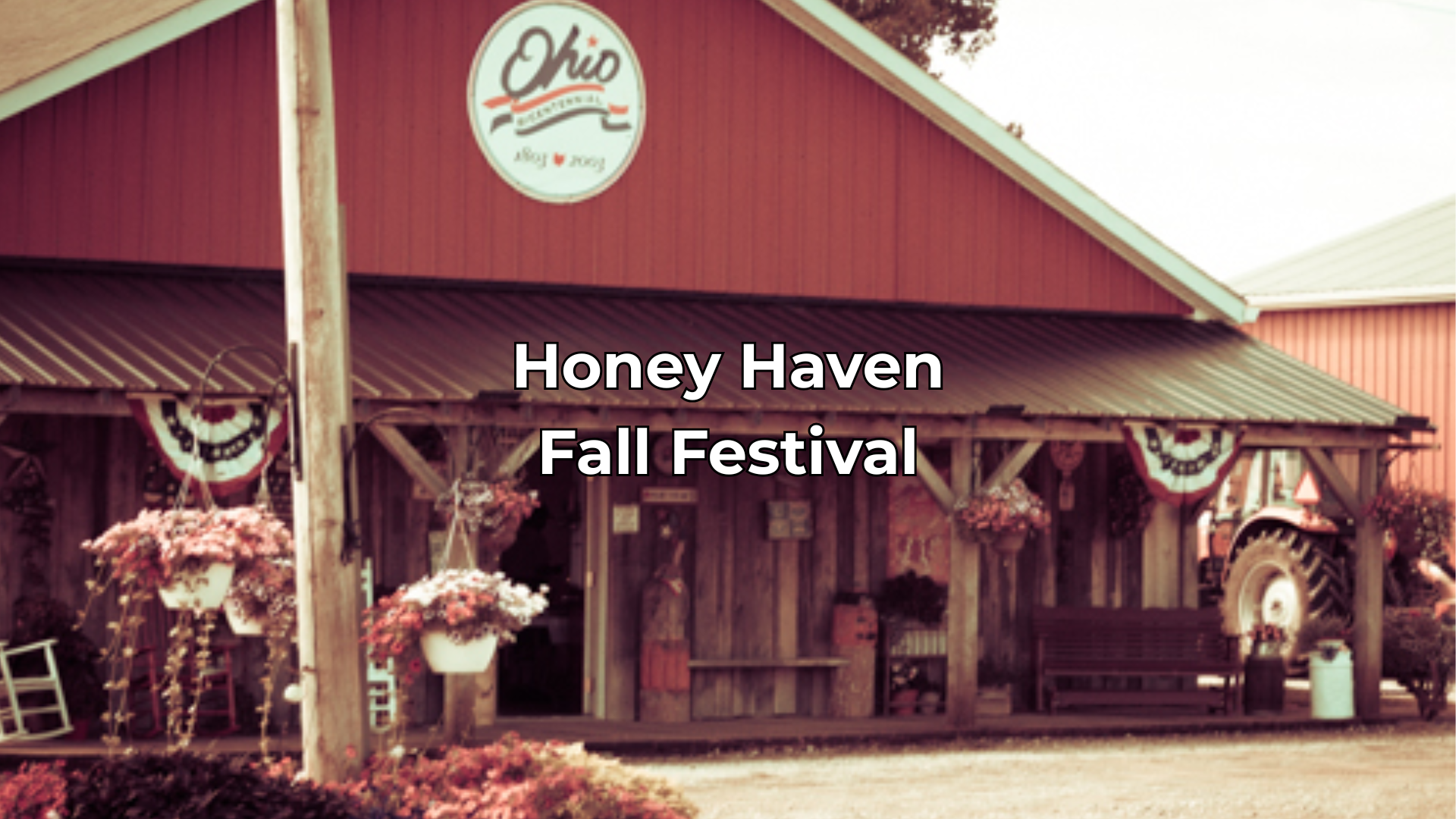 The front of the Honey Haven Country store in the fall with a big front porch and flowers