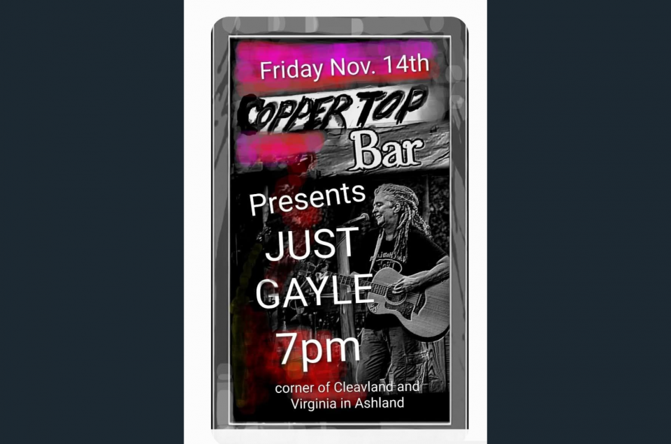 Gypsy Gayle singing and playing guitar