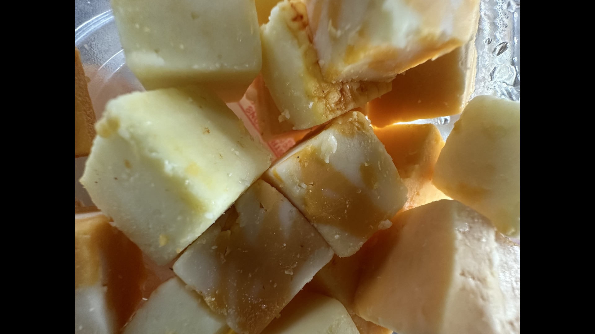 up close view of chunks of white cheddar and marbled cheddar cheese
